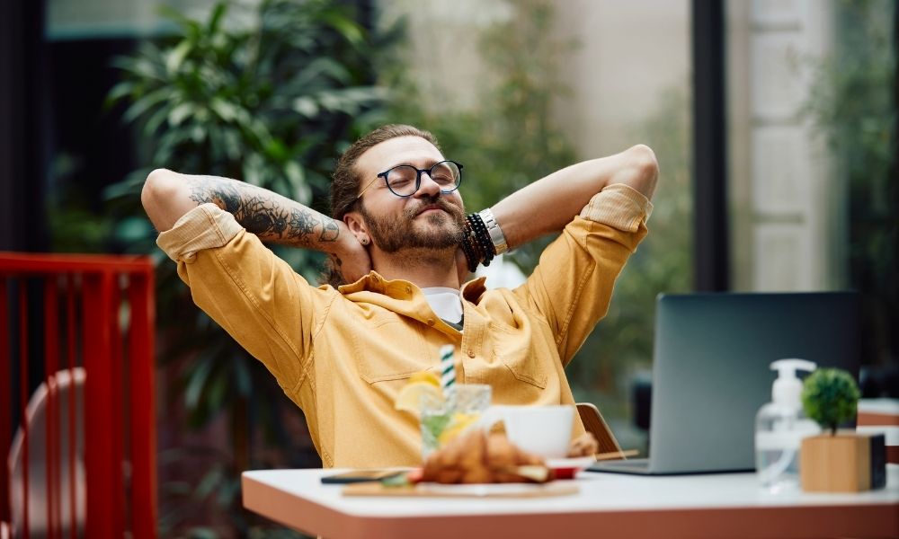 man-relaxes-with-eyes-closed-after-working